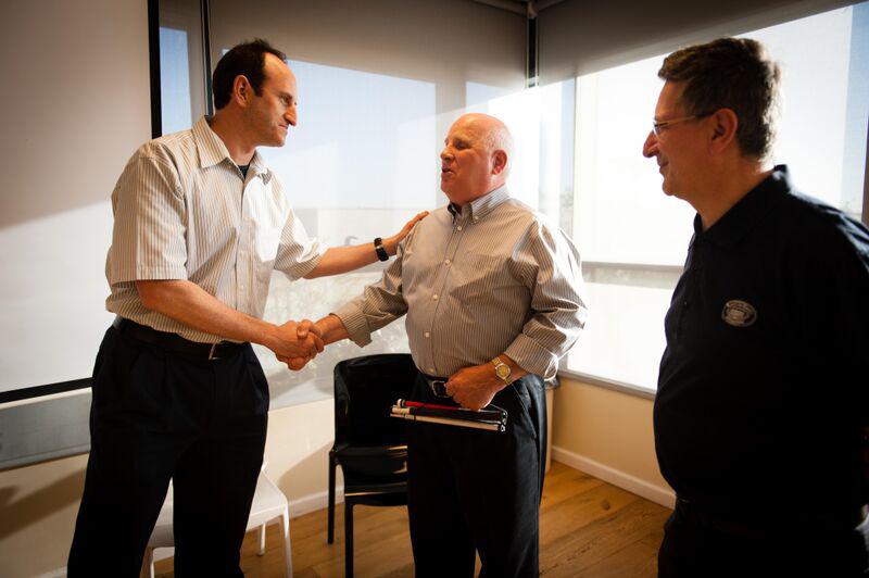 MyHeritage CEO Gilad Japhet greets Shep as MyHeritage genealogist Laurence Harris looks on